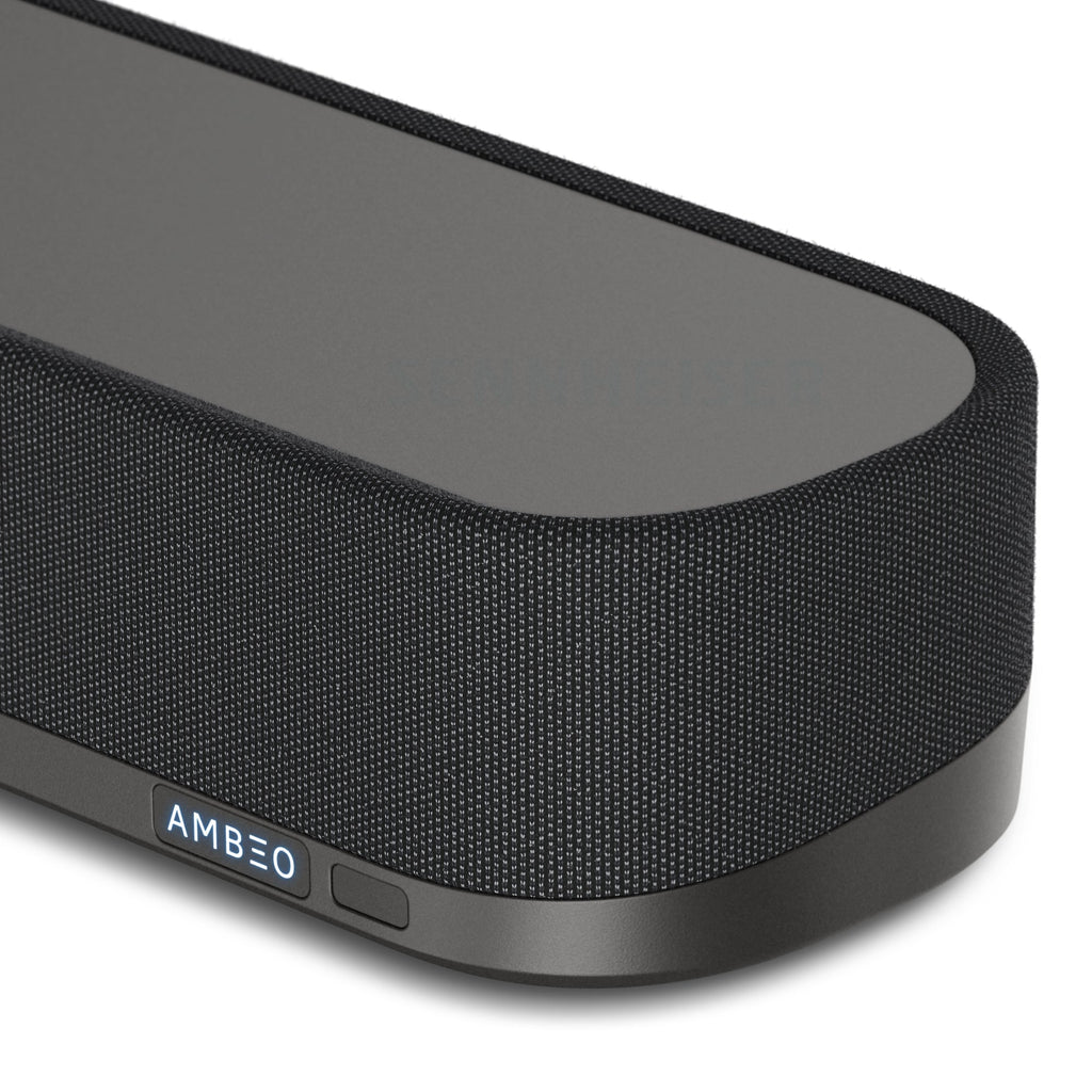 Close-up of the Sennheiser AMBEO Soundbar Mini in black color, showing the fabric speaker grill and the AMBEO logo.